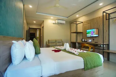 a bedroom with a large white bed with pillows at Sreepathi Prayag 11 Service Apartment in Guruvāyūr