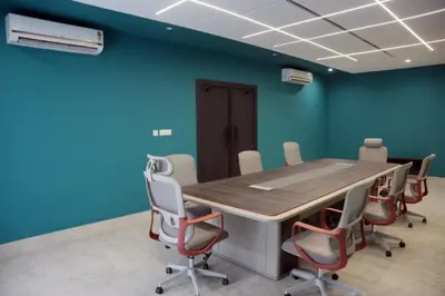 a conference room with a table and chairs at Alba Regency in Guruvāyūr