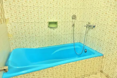 a shower with a blue tub in a bathroom at Nila Heavens - Spacious 5 BHK Homestay , ideal for families in Guruvāyūr