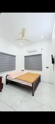 a room with a large bed in a room at Seascape Homestay Cherai Beach in Cochin