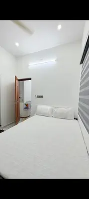 a large white bed in a white bedroom at Seascape Homestay Cherai Beach in Cochin
