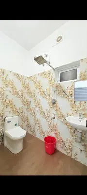 a bathroom with a toilet and a sink at Seascape Homestay Cherai Beach in Cochin