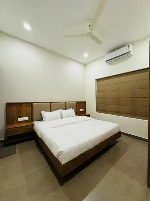 a bedroom with a large bed in a room at Zainab in Kozhikode