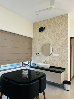 a bathroom with a black table and a sink at Zainab in Kozhikode