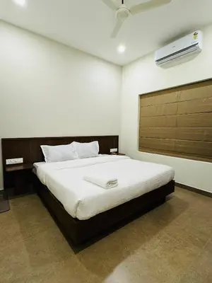 a bedroom with a large bed in a room at Zainab in Kozhikode