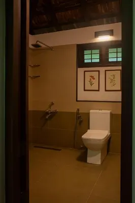 a bathroom with a toilet and a shower at Seethavanam Farmstay at Forest Edge in Kollengode