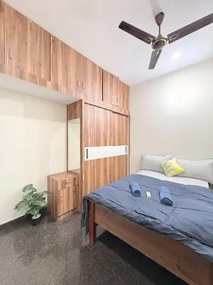 a bedroom with a bed and a ceiling fan at Kamadhenu Homestay, Comapact 1BHK OPP Mysore zoo, in Mysore