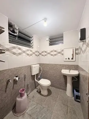 a bathroom with a toilet and a sink at Kamadhenu Homestay, Comapact 2BHK OPP Mysore zoo, A in Mysore