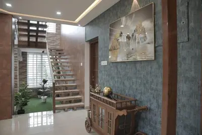 a lobby with a staircase and a stair case at Modern 5BR Villa in Thrissur in Trichūr