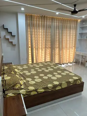 a large bed in a room with a large window at Modern 5BR Villa in Thrissur in Trichūr