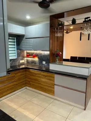 a kitchen with a counter with wood and stainless steel at Modern 5BR Villa in Thrissur in Trichūr