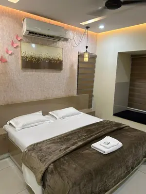 a bedroom with a large bed with two towels on it at Modern 5BR Villa in Thrissur in Trichūr