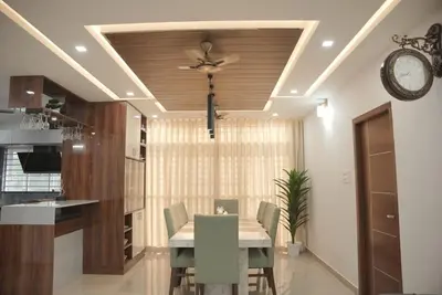 a dining room with a table and a ceiling fan at Modern 5BR Villa in Thrissur in Trichūr