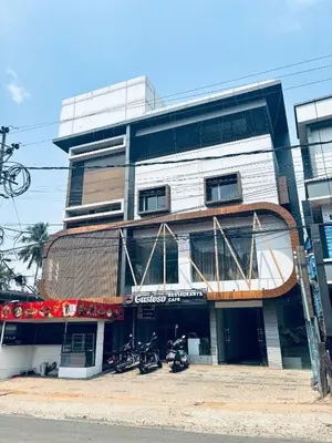 a building with motorcycles parked in front of it at Hotel Malabar Grand in Perintalmanna