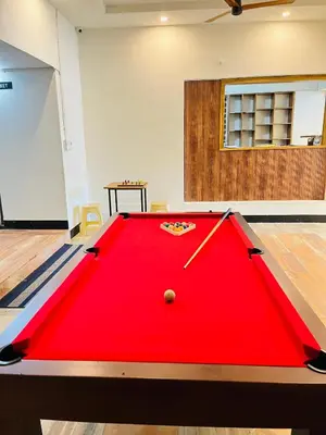a large red pool table in a room at LF Easybeds in Kozhikode