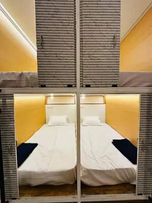 a room with two beds in a room at LF Easybeds in Kozhikode