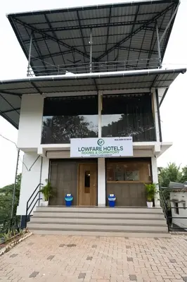 a building with a sign that reads lowerrance hotels at Lowfare Hotels Medical College in Kozhikode
