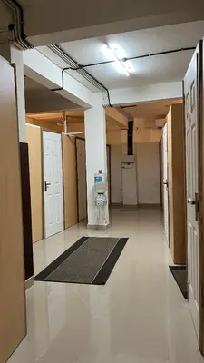 an empty room with a hallway with a room with a door at Lowfare Hotels Medical College in Kozhikode