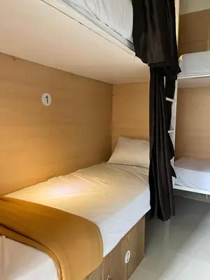 a small bedroom with two bunk beds in it at Lowfare Hotels Medical College in Kozhikode