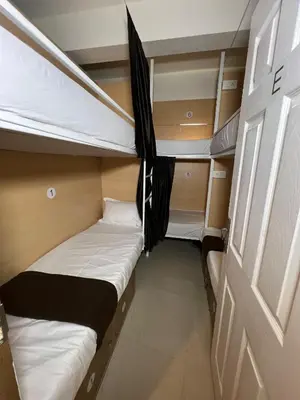 a small room with two bunk beds in it at Lowfare Hotels Medical College in Kozhikode