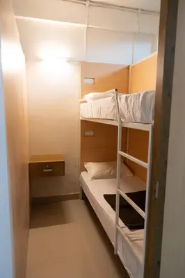 a small room with two bunk beds in it at Lowfare Hotels Medical College in Kozhikode