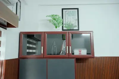 a wooden cabinet with a plant on top of it at TREE 9 Lounge -Cochin Airport in Nedumbassery