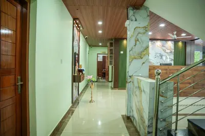 a hallway of a building with a staircase and a lobby at TREE 9 Lounge -Cochin Airport in Nedumbassery