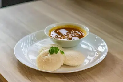 a plate of food with a bowl of soup and biscuits at TREE 9 Lounge -Cochin Airport in Nedumbassery