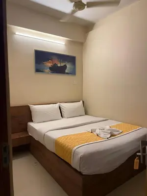 a bedroom with a large bed in a room at HG Tower 2 in Kunnamangalam
