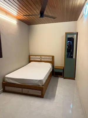 a bedroom with a bed and a mirror at HG Tower 2 in Kunnamangalam