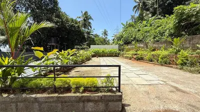 a garden with a fence and some plants at HG Tower 2 in Kunnamangalam