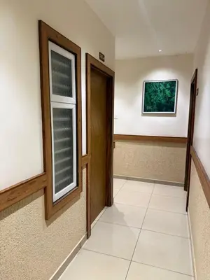 an empty hallway with a door and a window at HG Tower 2 in Kunnamangalam