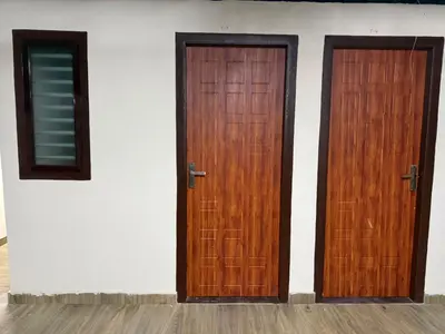 two wooden doors on the side of a building at HG Tower 2 in Kunnamangalam