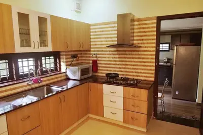 a kitchen with a sink and a microwave at Niki Haven in Kāladi