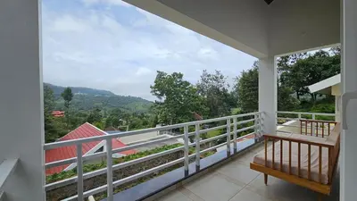 a balcony with a view of the mountains at Mayfield Valley Homestay in Kotagiri