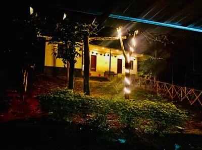 a house at night with lights in front of it at Chembani Holidays and Resorts Kanthalloor in Kanthalloor