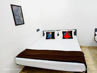 a white bed with pillows on it in a room at Chembani Holidays and Resorts Kanthalloor in Kanthalloor