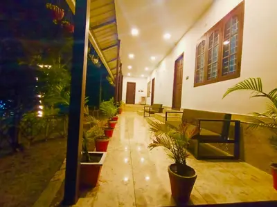 a hallway with potted plants in a building at Chembani Holidays and Resorts Kanthalloor in Kanthalloor