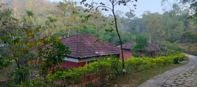 a small house on the side of a road at The Crescent Wayanad Heritage Pool Resort in Sultan Bathery