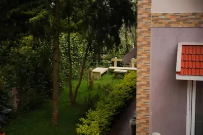 a garden with a bench and a picnic table at Willostays Cloudhill ooty in Ooty
