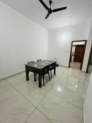 a ping pong table in a room with a ceiling fan at CT HOMESTAY, Omassery in Tāzhekkod