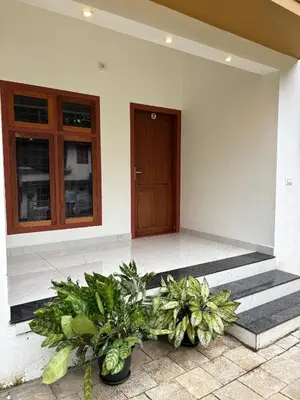 a house with some plants in front of a door at CT HOMESTAY, Omassery in Tāzhekkod