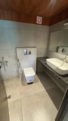 a bathroom with a sink and a toilet at Deshadan Jungle in Kanthalloor