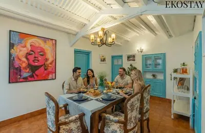 a group of people sitting around a dining room table at EKOSTAY - Casa Del Sol in Ooty