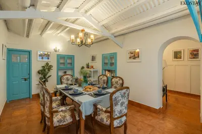 a dining room with a table and chairs at EKOSTAY - Casa Del Sol in Ooty