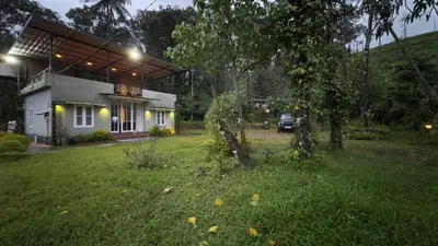 a house with a yard in front of a building at Country Side Inn in Vayittiri
