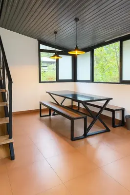 a dining room with a table and some windows at Country Side Inn in Vayittiri