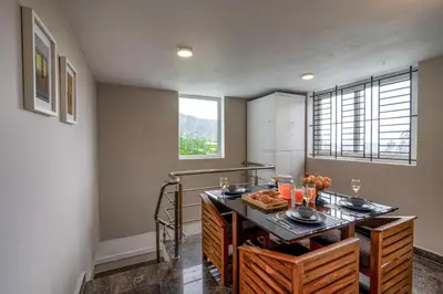 a kitchen with a table with food on it at EKOSTAY - Garden Grove Villa in Ooty