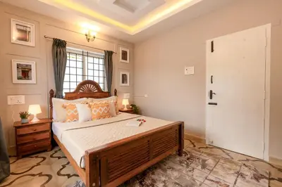 a bedroom with a large bed and a window at EKOSTAY - Garden Grove Villa in Ooty