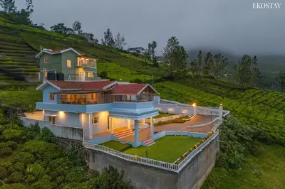a large house on top of a hill at EKOSTAY - Garden Grove Villa in Ooty